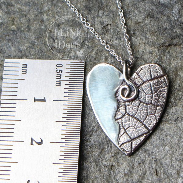 Blinkidees Sterling silver heart pendant with leaf texture on a chain.
