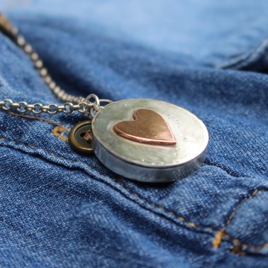 A two-piece sterling silver photo locket with a hidden secret message